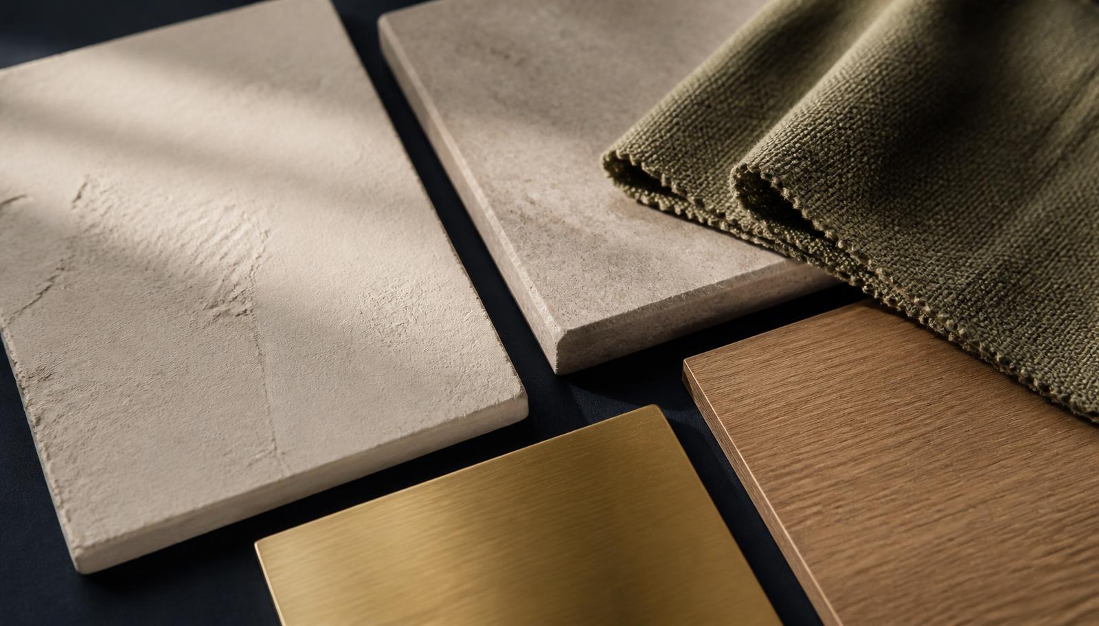 Natural interior material samples arranged on a deep navy surface